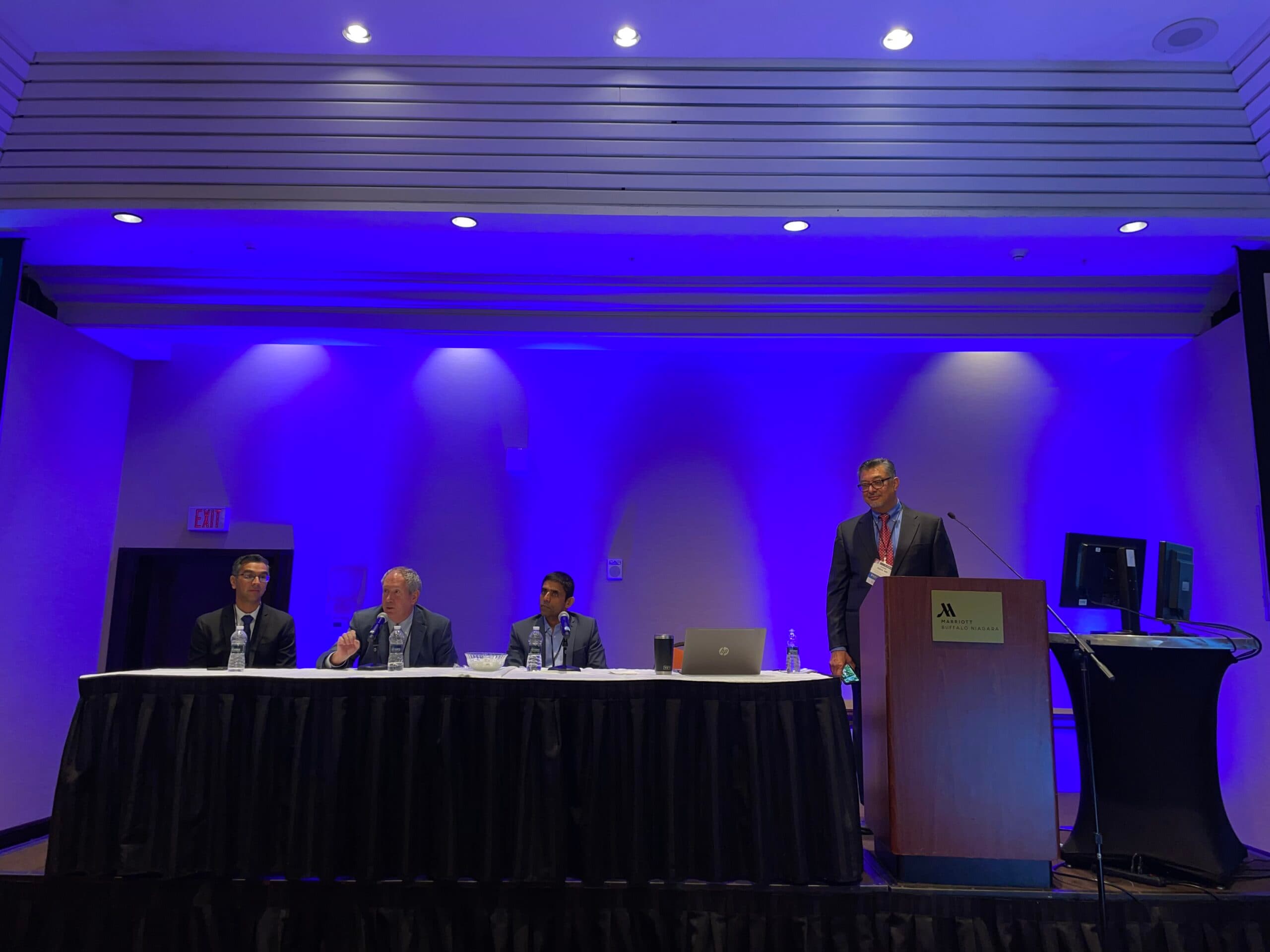 Faculty panel on stage at a past VIA Symposium
