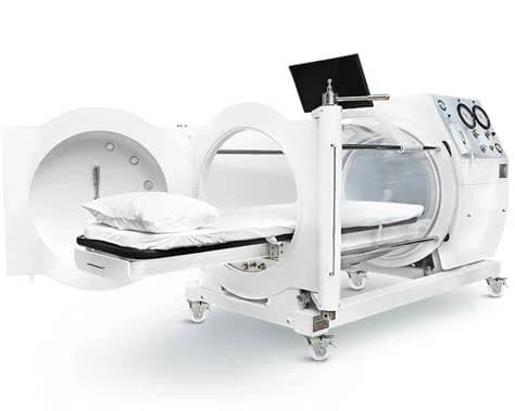 Monoplace hyperbaric oxygen therapy chamber with its patient bed extended