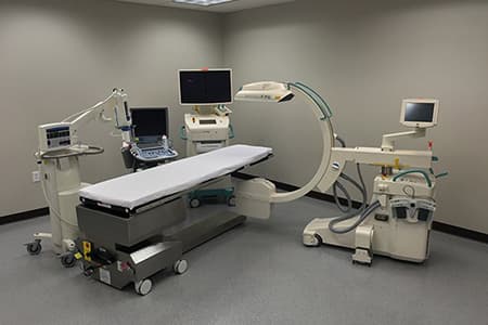 Buffalo Vascular Care procedure suite with a C-arm fluoroscopy imaging system and procedure table
